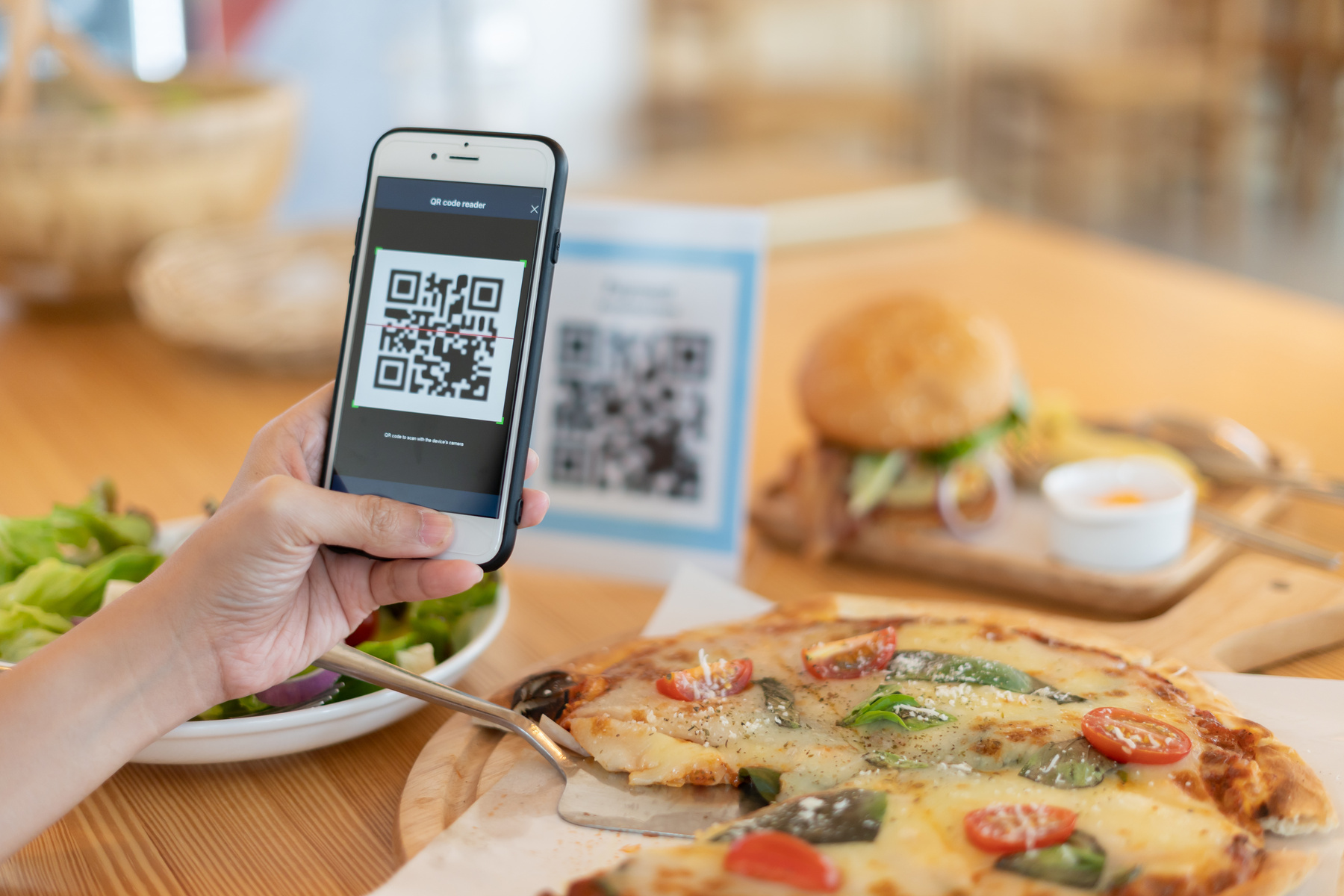 Woman use smartphone to scan QR code to pay in cafe restaurant w